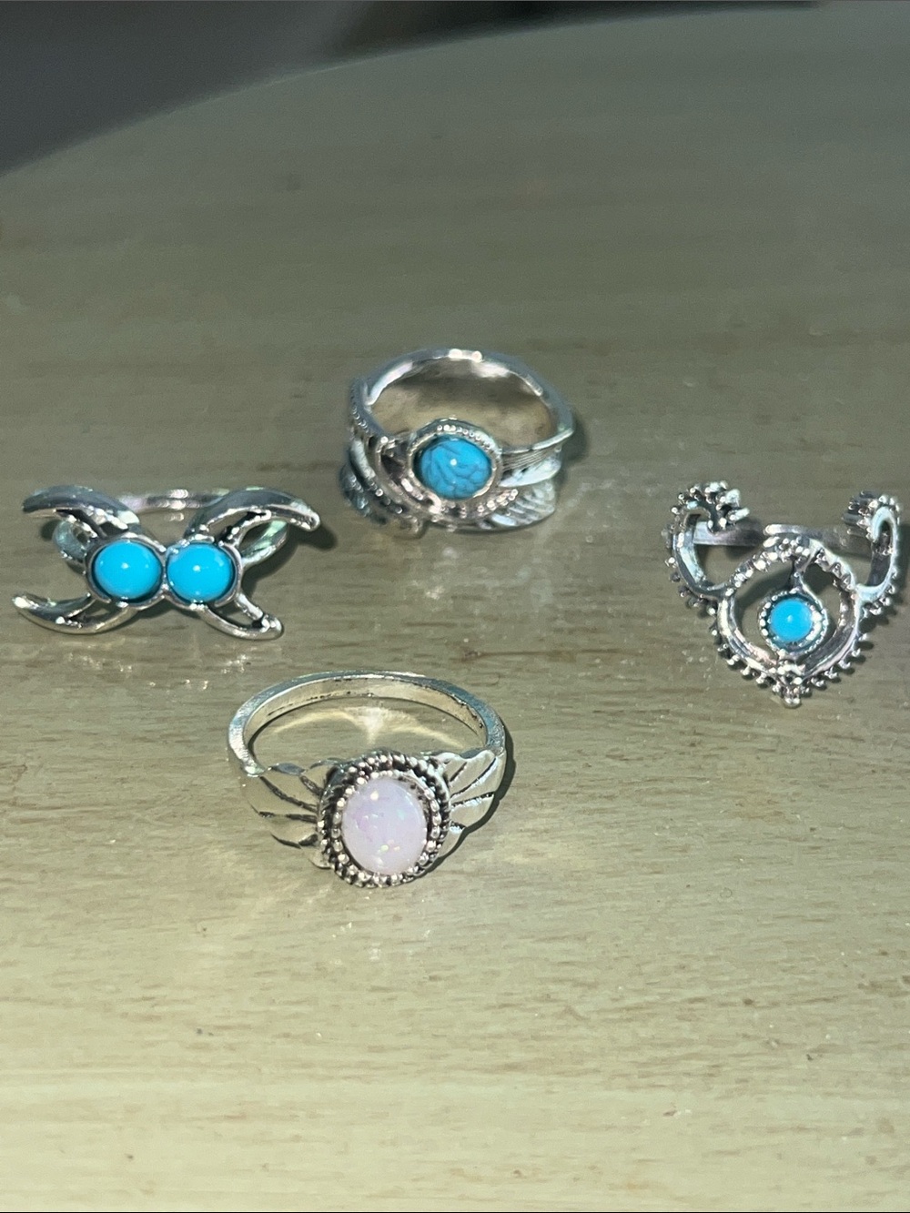 Turquoise and opal style rings in silver tone bands - sold as a bundle of 4